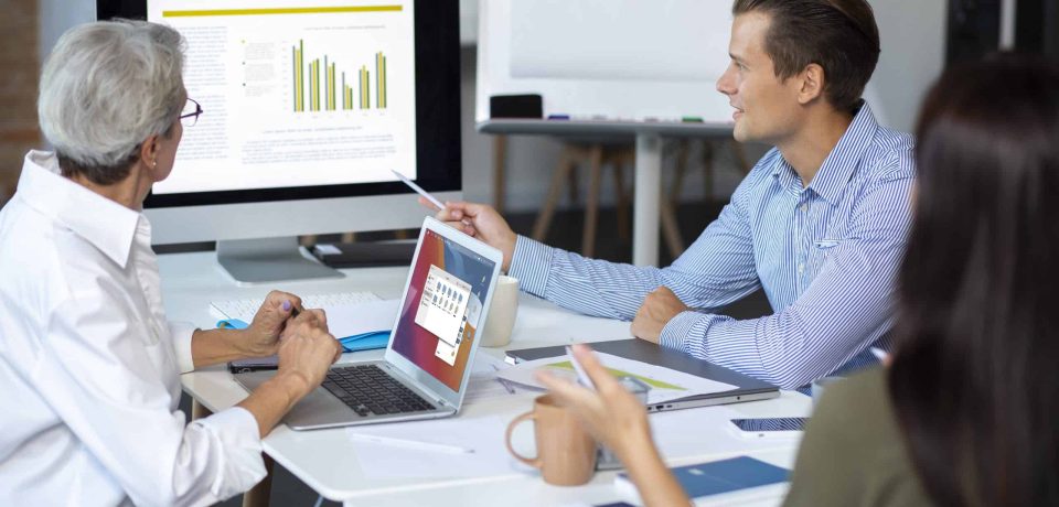 people-using-digital-device-while-meeting-scaled Essential Best Practices for Successful ERP Implementation